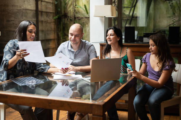 istock Real estate agent or finance advisor doing a meeting with customers at home 1324925749