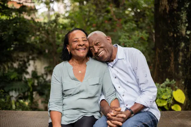 Photo of Portrait of a happy senior couple sitting together outdoors