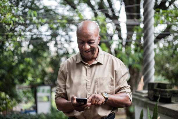 istock Senior man using smartphone outdoors 1324925854