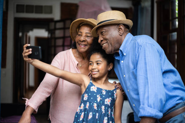 Girl taking selfie with grandparents during vacations