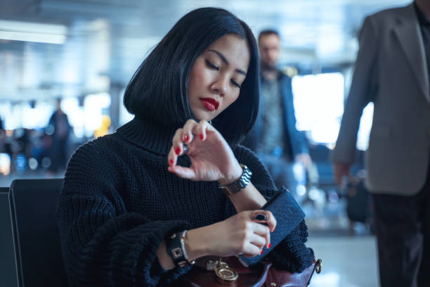 istock Waiting for flight at airport terminal, checking the time 1324926811