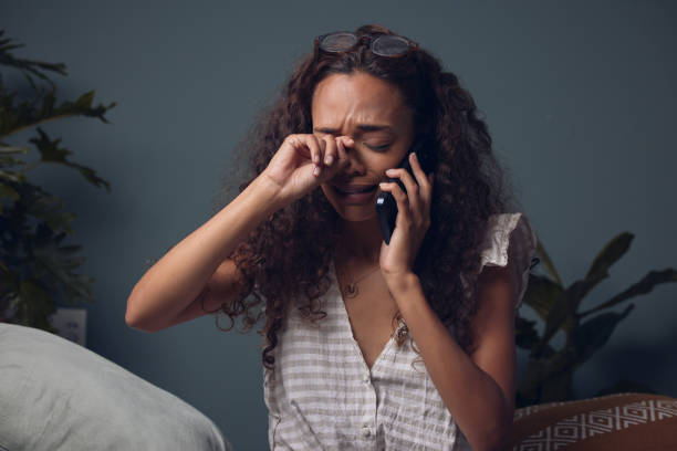 istock Shot of a woman crying while talking on her cellphone 1324929519