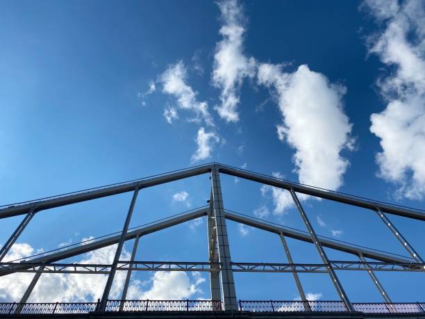 istock Bridge against blue sky and white clouds at sunny summer day. 1324929575