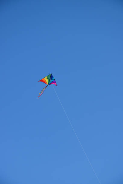 istock Colorful kite against blue sky 1324932212