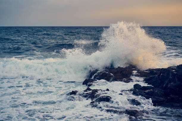 istock Splashes from the waves bumping against the rocky shore 1324932928