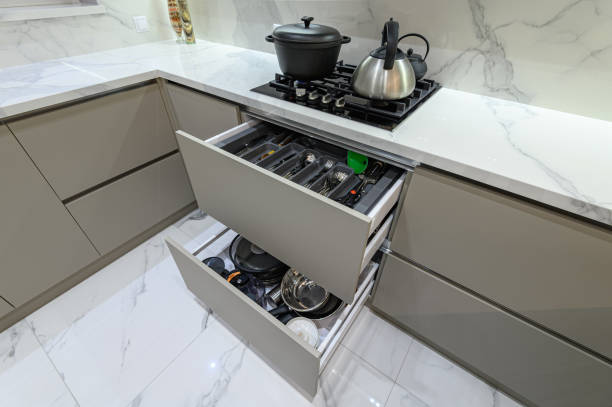 istock Open drawer with cutlery at modern white woden kitchen in classic style 1324933095