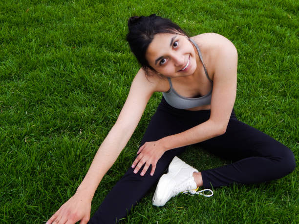 istock Woman exercising in the park 1324935623
