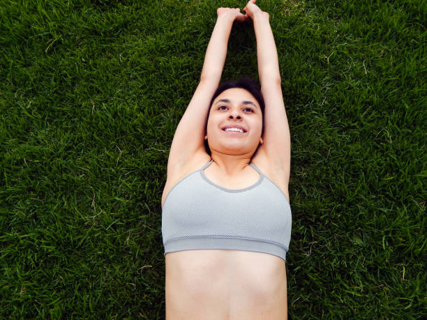 istock Woman exercising in the park 1324936469
