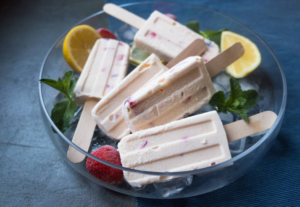 Creamy popsicles with lemon curd stock photo