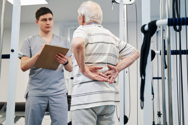 istock Senior patient telling doctor about his backache 1324940502