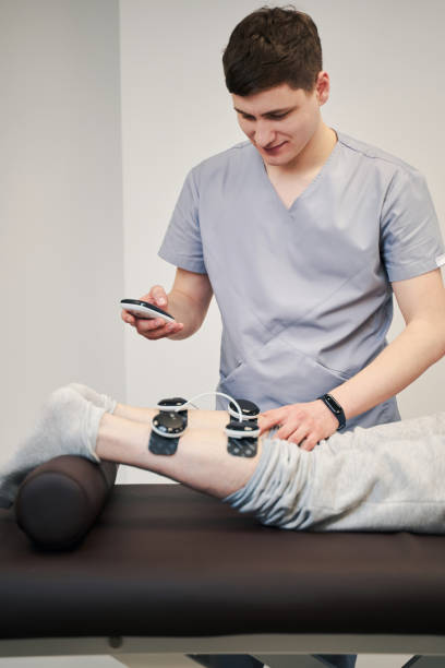 istock Orthopedist is clicking on muscle stimulator screen 1324940565