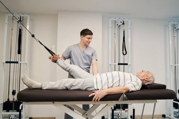 istock Person doing leg exercise with foot attached to resistance band 1324940592