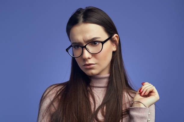 istock Girl with displeased expression, curves lips and looks with sad expression 1324945453