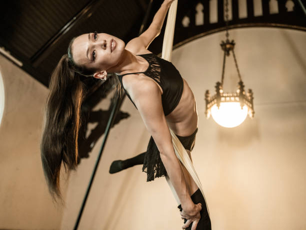 istock Young female aerial silk performer at practice 1324946221