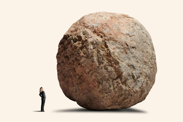 istock Woman Looking Up At Big Rock 1324947031