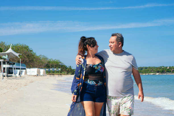 istock Mature Married Couple Hugging Each Other Standing At The Beach 1324952660