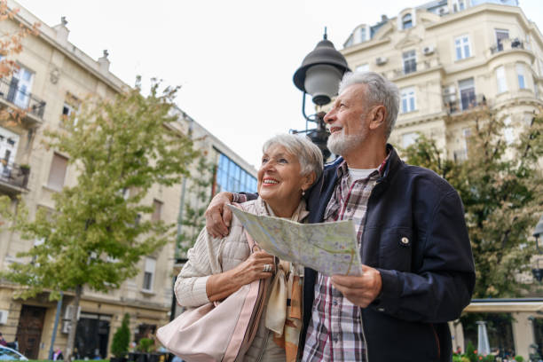 istock Older Travelers are Sightseeing the City During a Vacation Using a City Map. 1324954202