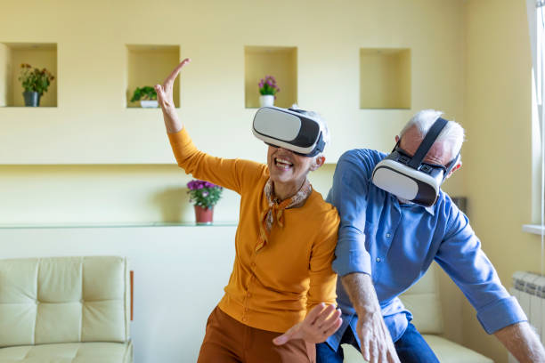 istock Excited Senior Couple is Experiencing Games on Virtual Reality Simulator with VR Glasses. 1324954967