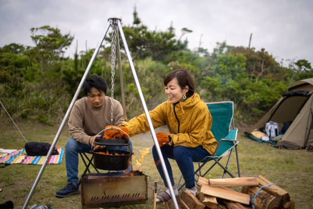 istock Young couple cooking at camp 1324956931