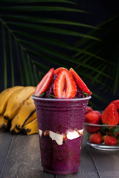 Acai cup with strawberry topping. The popular Brazilian acai smoothie. acai stock pictures, royalty-free photos & images