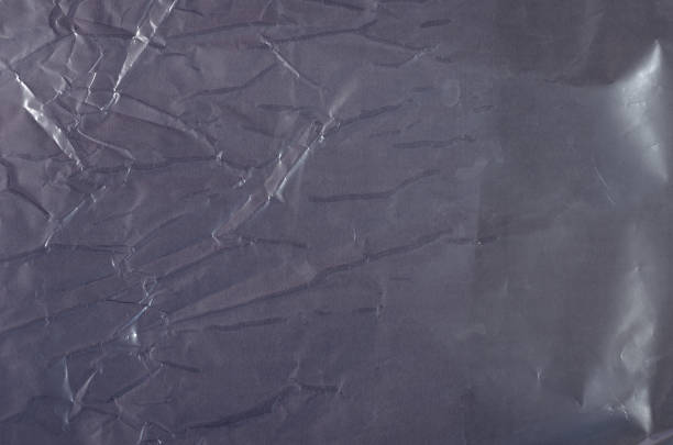 istock A gray-pink crumpled glossy surface. Shot Of colored Packing Tex 1324961839