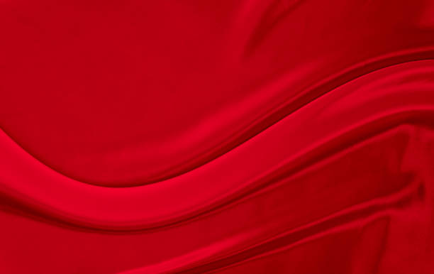 istock Black red satin dark fabric texture luxurious shiny that is abstract silk cloth background with patterns soft waves blur beautiful. 1324965669