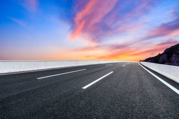 istock Empty road and colorful cloud at sunrise. 1324967417