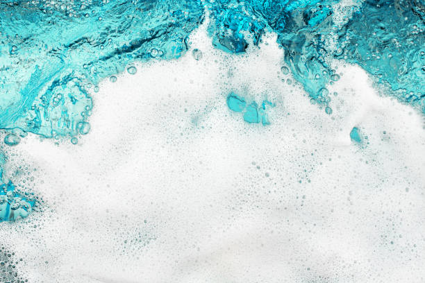 istock White foam blue water background closeup, sea or ocean foam wave pattern, froth bubbles texture, soap spume backdrop, cleaning soap sud, lather surface, soapy detergent, laundry, foamy bathtub, shower 1324967449