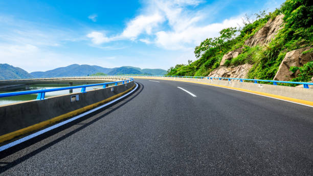 istock Empty road and mountains natural landscape. 1324969112