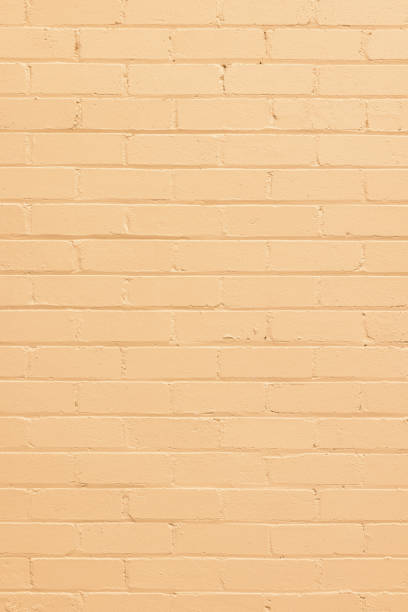istock Part of a brick wall painted yellow 1324971417