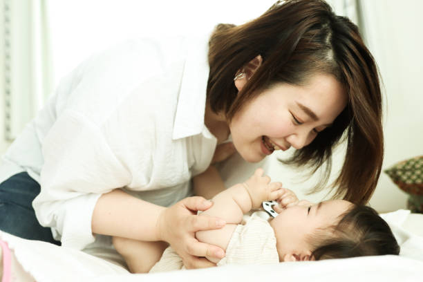istock Asian Mother Playing with Baby 1324971455