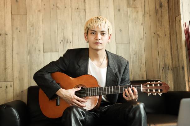 istock Musician Holding a Guitar 1324971645