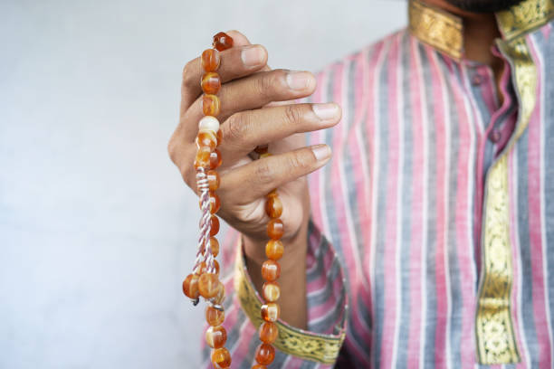 istock muslim man keep hand in praying gestures during ramadan, Close up 1324974722