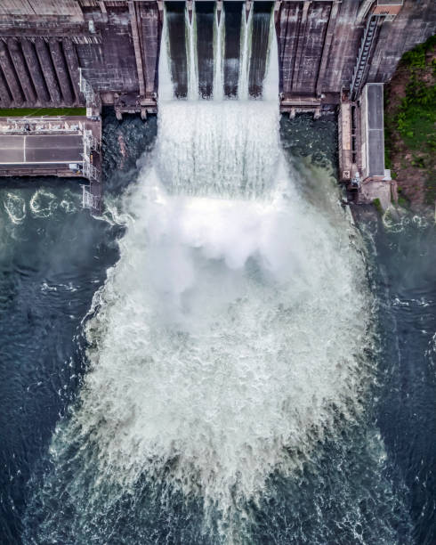 water discharge stream waterfall at the hydroelectric dam. an overflowing reservoir, a huge jet of water, aerial , a drone, the Yenisei river siberia Krasnoyarsk stock photo