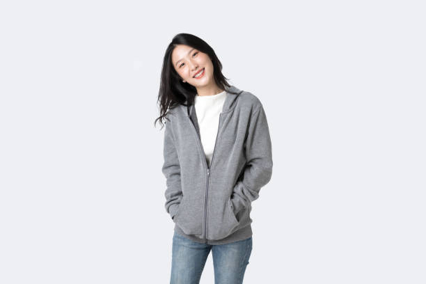 Portrait beautiful  Asian woman in hoodie sweatshirt and blue jeans isolated over white background stock photo