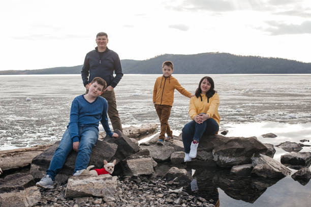 istock A young family is resting on the riverbank. 1324983382