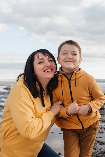 istock Mom and son on the river bank. 1324983397