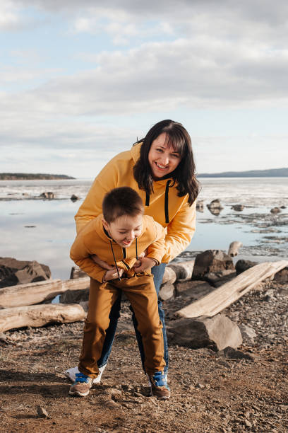 istock Mom plays with her son on the riverbank 1324983435