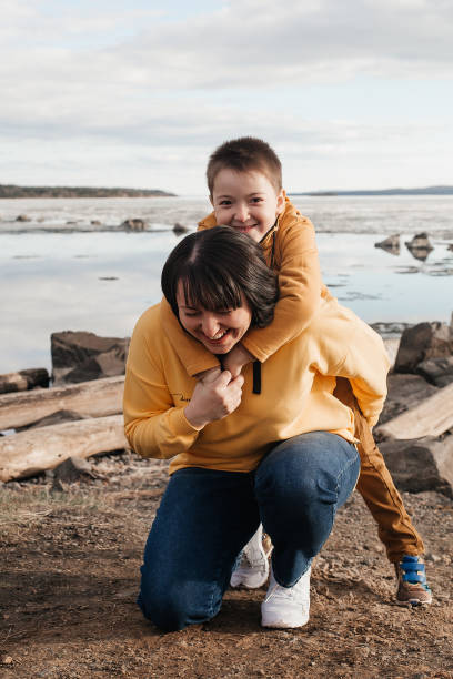 istock Mom plays with her son on the riverbank 1324983456