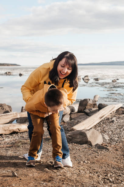 istock Mom plays with her son on the riverbank 1324983459