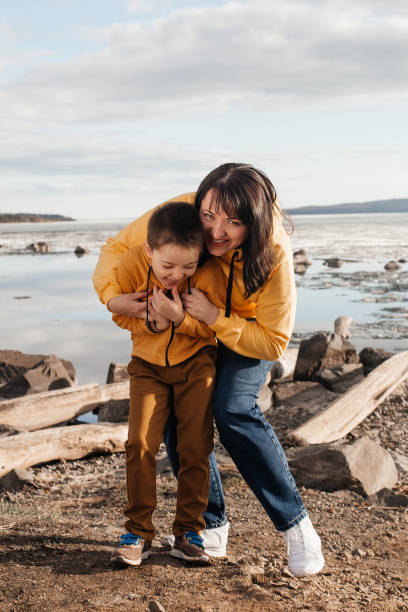 istock Mom plays with her son on the riverbank 1324983471