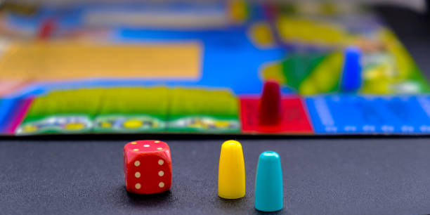 Dice for board games on black background. Board game with multi-colored cubes on table game. Stay home leisure activity