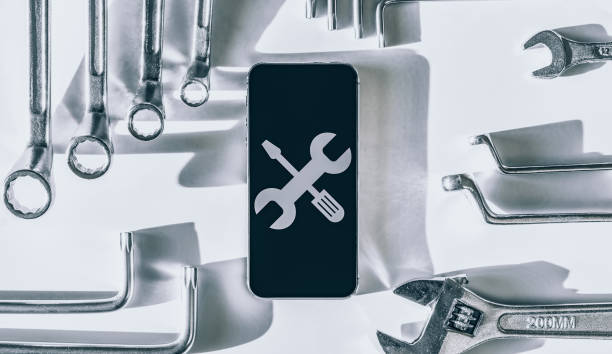 istock Smartphone service. Technician workplace with phone and special repairing tools. Electronic smart phone technology service. 1324989829