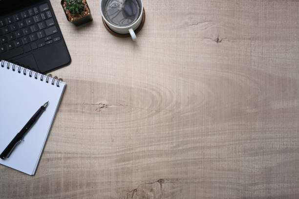 istock Top view notepad, laptop and coffee cup on wooden background. 1324990876