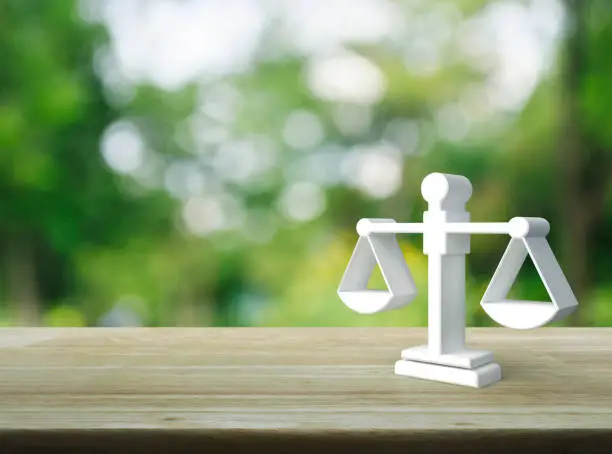 Law 3d icon on wooden table over blur green tree in park, Business legal service concept