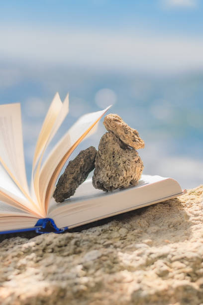 istock small stones on the pages of an open book 1324992504