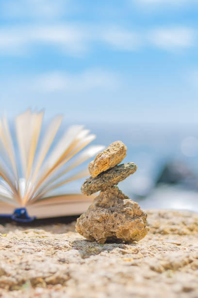 istock small stones on the background of an open book 1324992514
