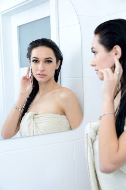 istock Beautiful brunette in front of mirror 1324994656