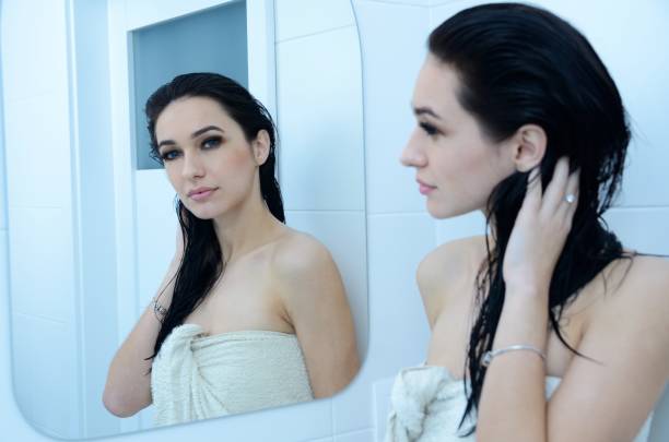 istock Beautiful brunette in front of mirror 1324994681