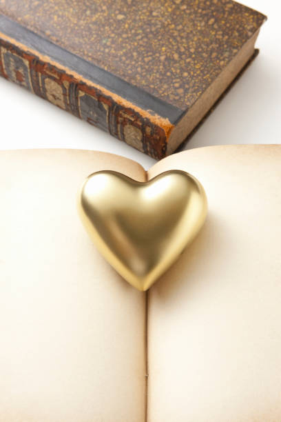 istock Gold heart and antique book 1324995326